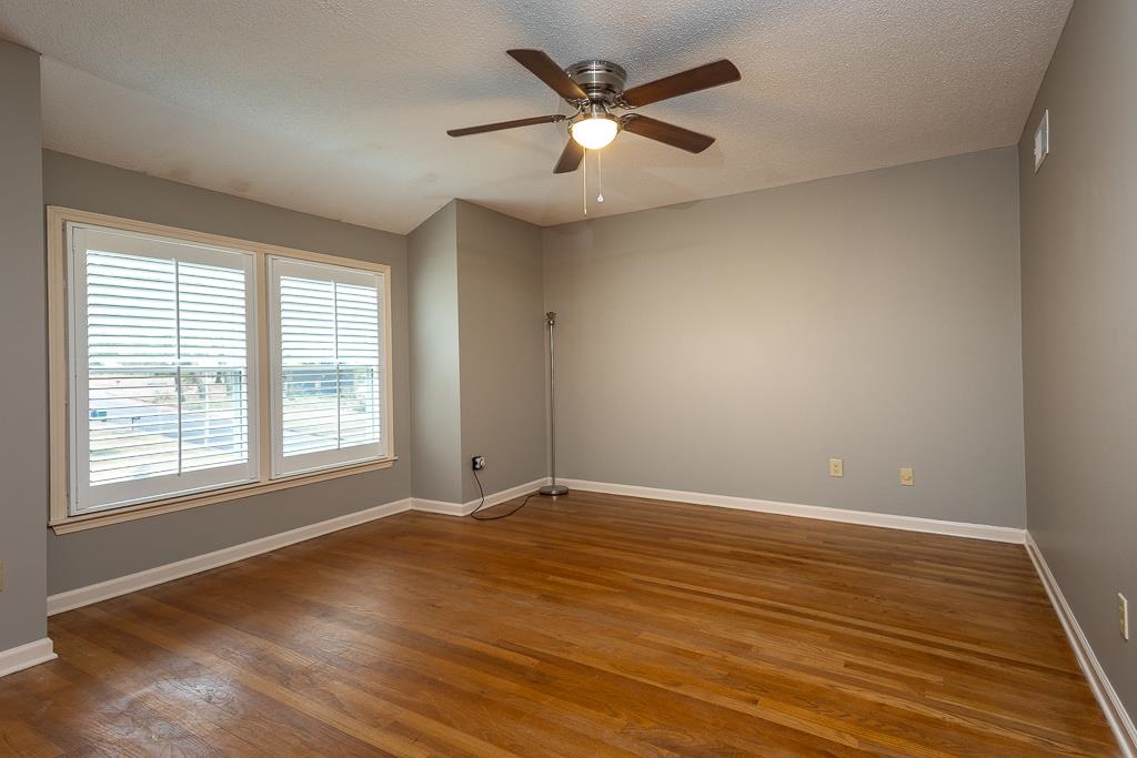 6932 Great Oaks Road Germantown, TN 38138 - Photo 13 of 20 an empty room with wooden floor and windows