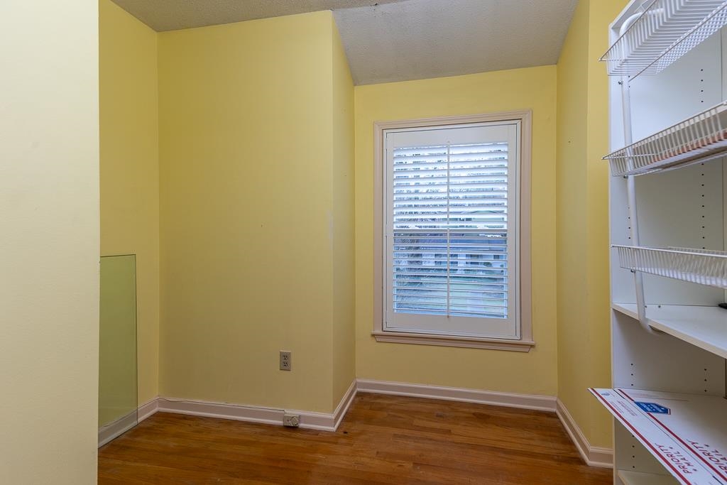 6932 Great Oaks Road Germantown, TN 38138 - Photo 14 of 20 a view of an empty room with wooden floor and a window