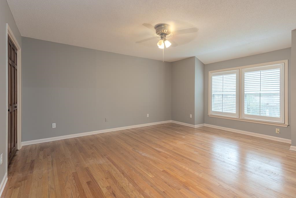 6932 Great Oaks Road Germantown, TN 38138 - Photo 15 of 20 a view of an empty room with wooden floor and a window
