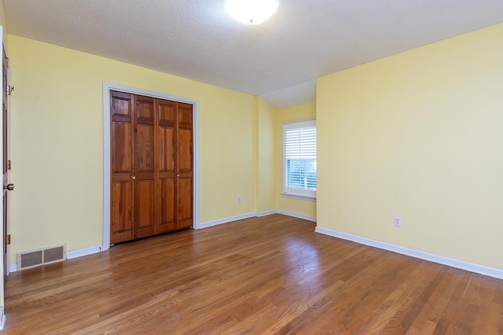 6932 Great Oaks Road Germantown, TN 38138 - Photo 16 of 20 an empty room with wooden floor and windows