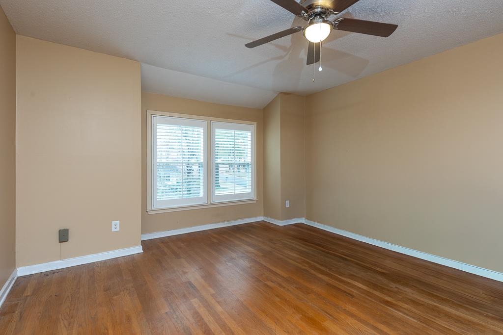 6932 Great Oaks Road Germantown, TN 38138 - Photo 17 of 20 a view of an empty room with window and wooden floor
