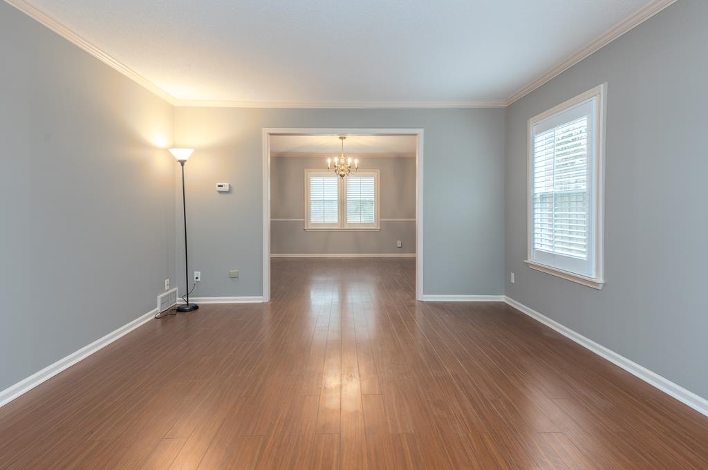 6932 Great Oaks Road Germantown, TN 38138 - Photo 2 of 20 an empty room with wooden floor and windows