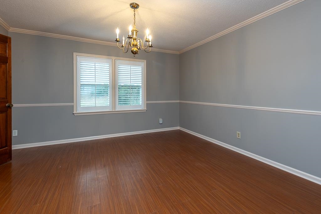6932 Great Oaks Road Germantown, TN 38138 - Photo 3 of 20 a view of an empty room with wooden floor and a window