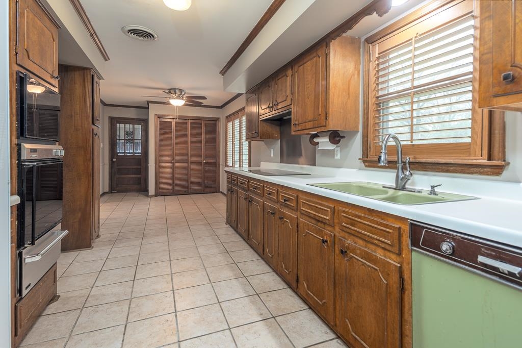 6932 Great Oaks Road Germantown, TN 38138 - Photo 5 of 20 a large kitchen with kitchen island granite countertop a large counter top space appliances and cabinets