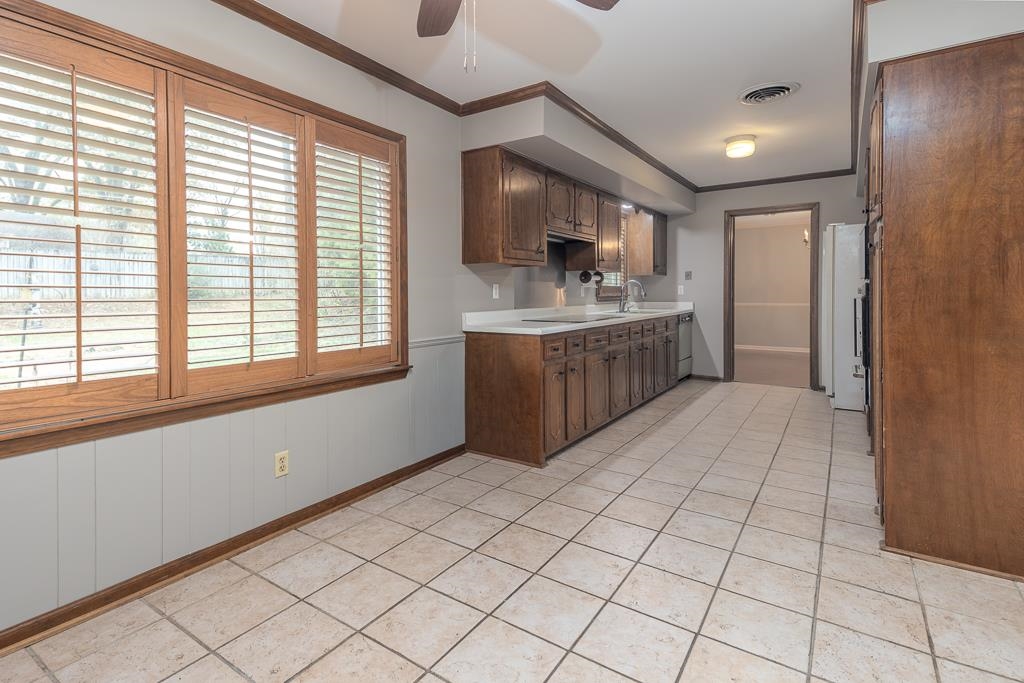 6932 Great Oaks Road Germantown, TN 38138 - Photo 7 of 20 a kitchen with stainless steel appliances kitchen island granite countertop a sink and cabinets
