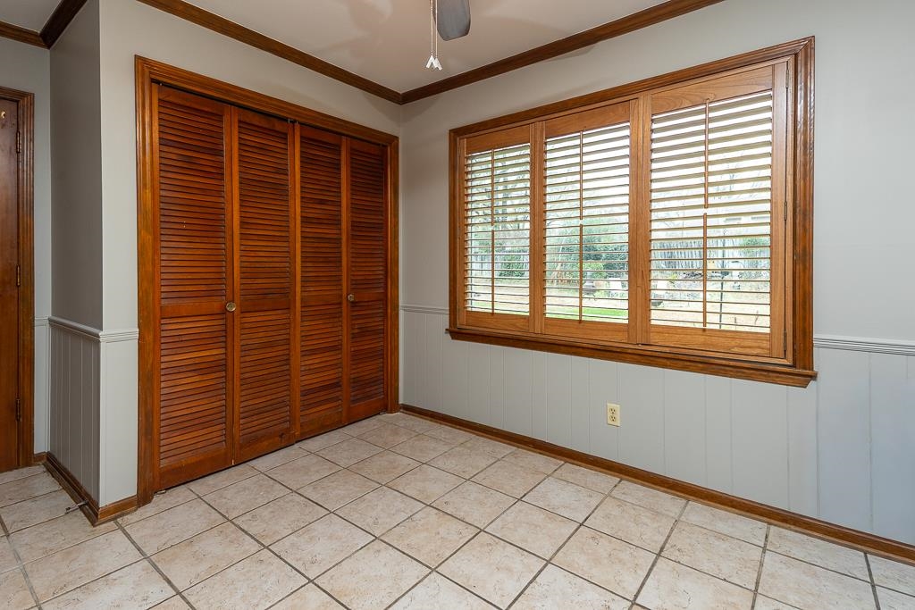 6932 Great Oaks Road Germantown, TN 38138 - Photo 8 of 20 a view of an empty room with wooden floor and a window