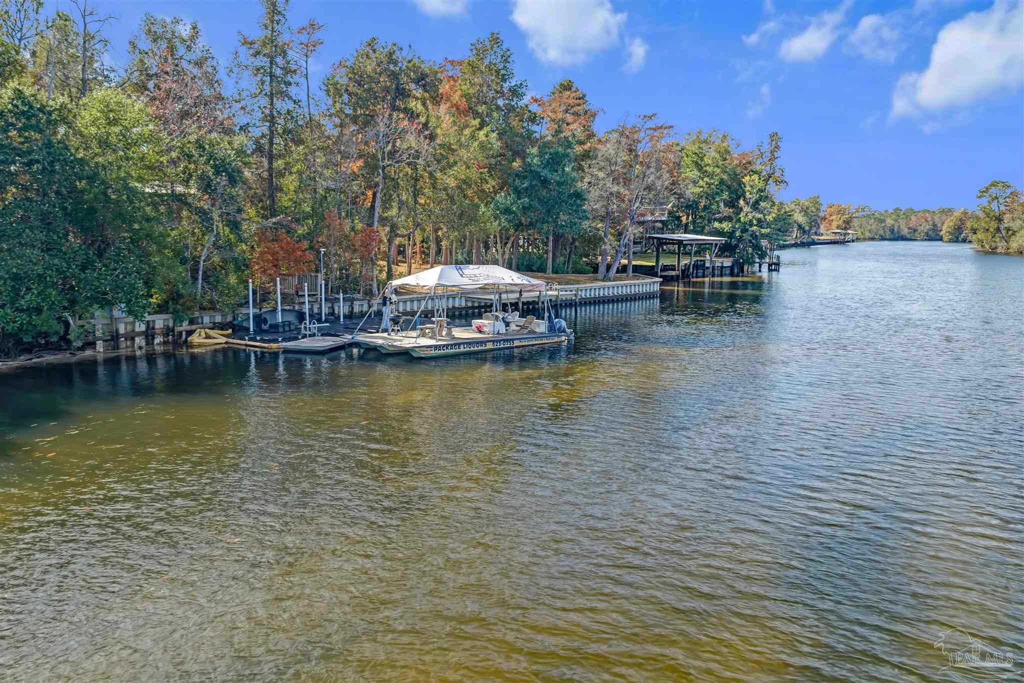 7784 River Road Milton, FL 32583 - Photo 16 of 21 a view of a lake with outdoor seating space