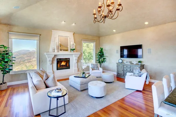 a living room with fireplace furniture and a flat screen tv