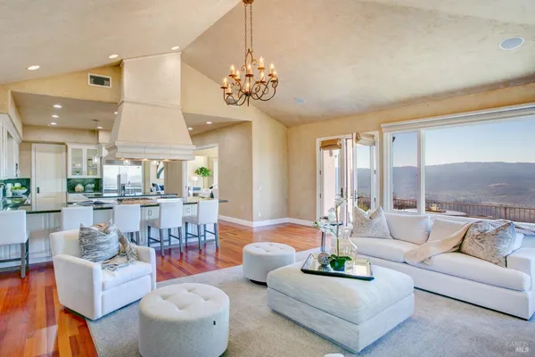 a kitchen with stainless steel appliances granite countertop a sink a stove and a refrigerator
