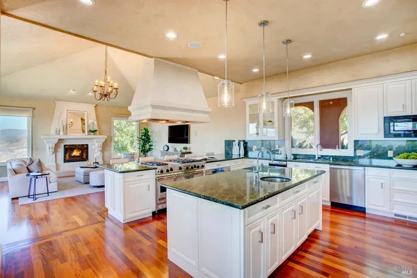 a dining room with wooden floor and furniture