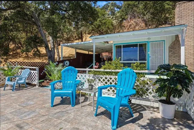 a view of a chairs and tables in the patio in front of a house