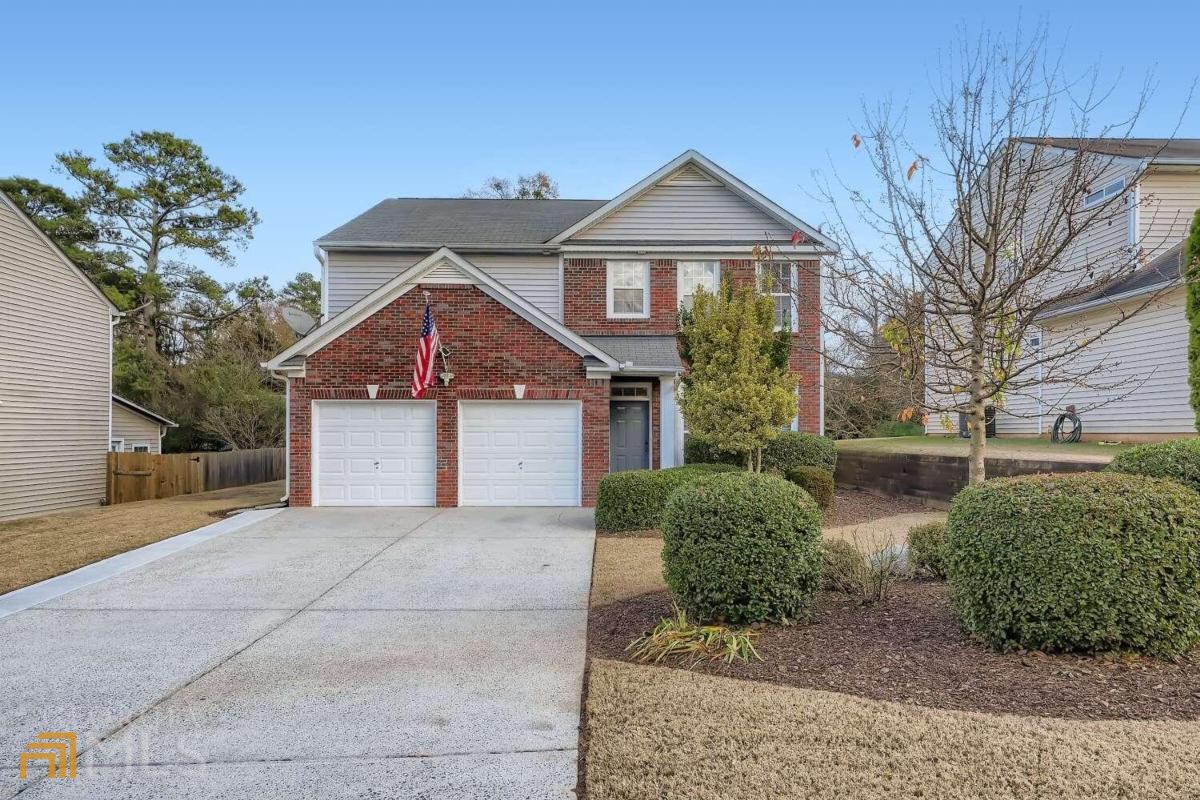 2093 Ridgestone Landing Southwest Marietta, GA 30008 - Photo 1 of 1 a front view of a house with a yard and garage