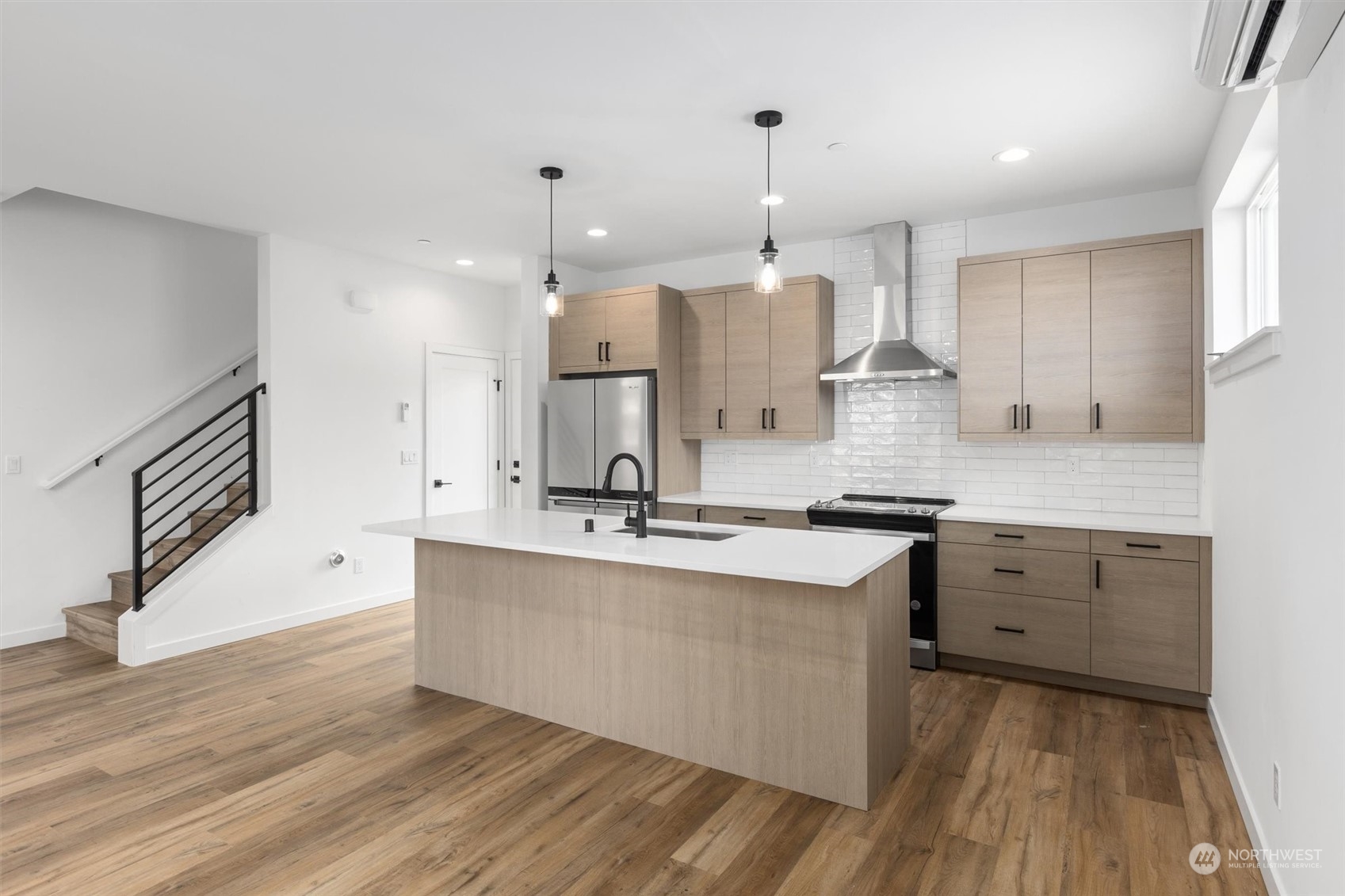 4211 Southwest Raymond Street Seattle, WA 98136 - Photo 3 of 27 a large kitchen with cabinets wooden floor and stainless steel appliances