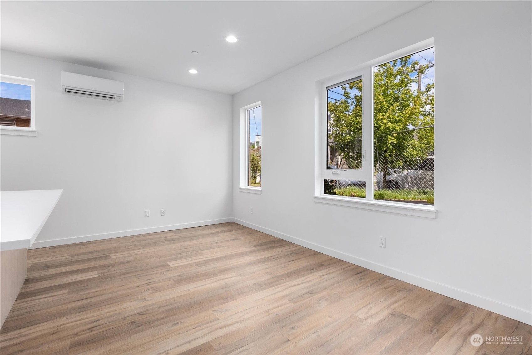 4211 Southwest Raymond Street Seattle, WA 98136 - Photo 4 of 27 a view of an empty room with wooden floor and a window