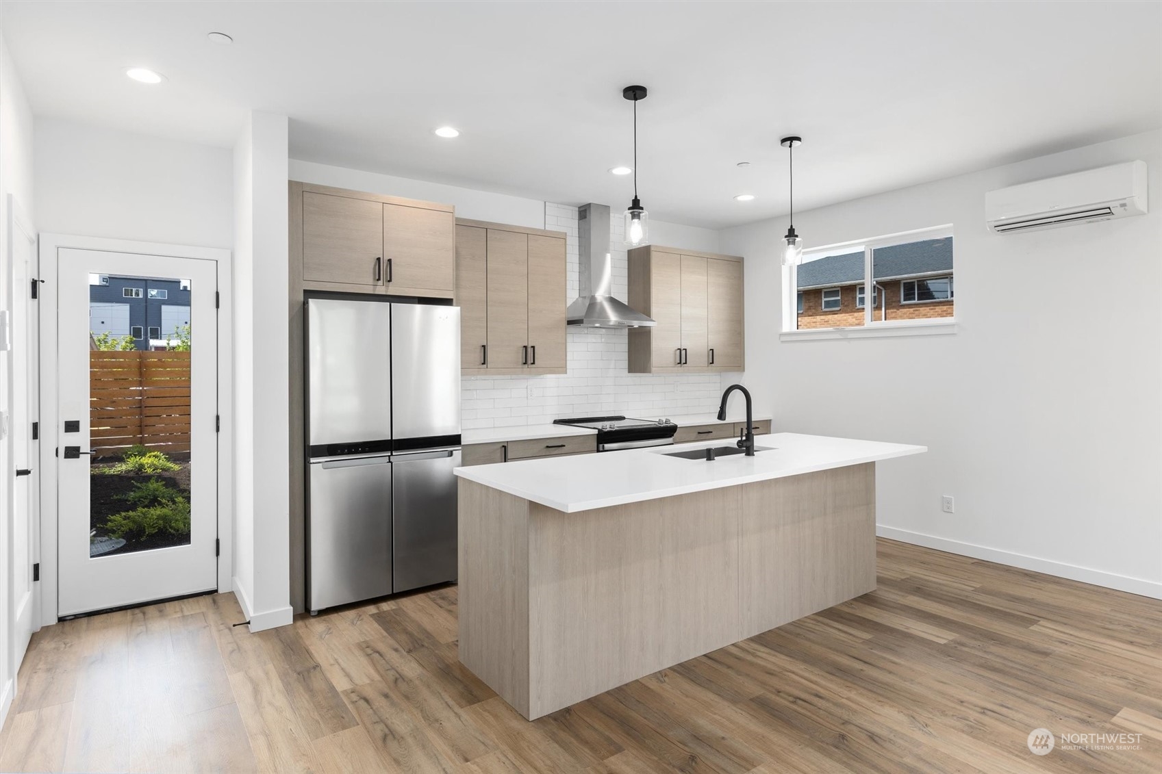 4211 Southwest Raymond Street Seattle, WA 98136 - Photo 5 of 27 a kitchen with stainless steel appliances granite countertop a sink a stove a refrigerator and island with wooden floor