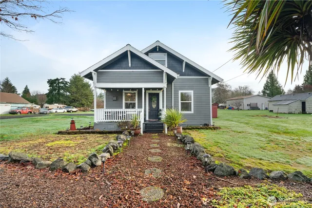 a view of a house with a yard patio and fire pit