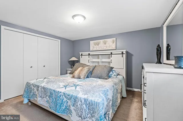 a bedroom with a bed and a television