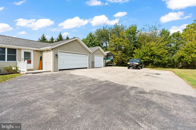 a view of a house with a yard and potted plants
