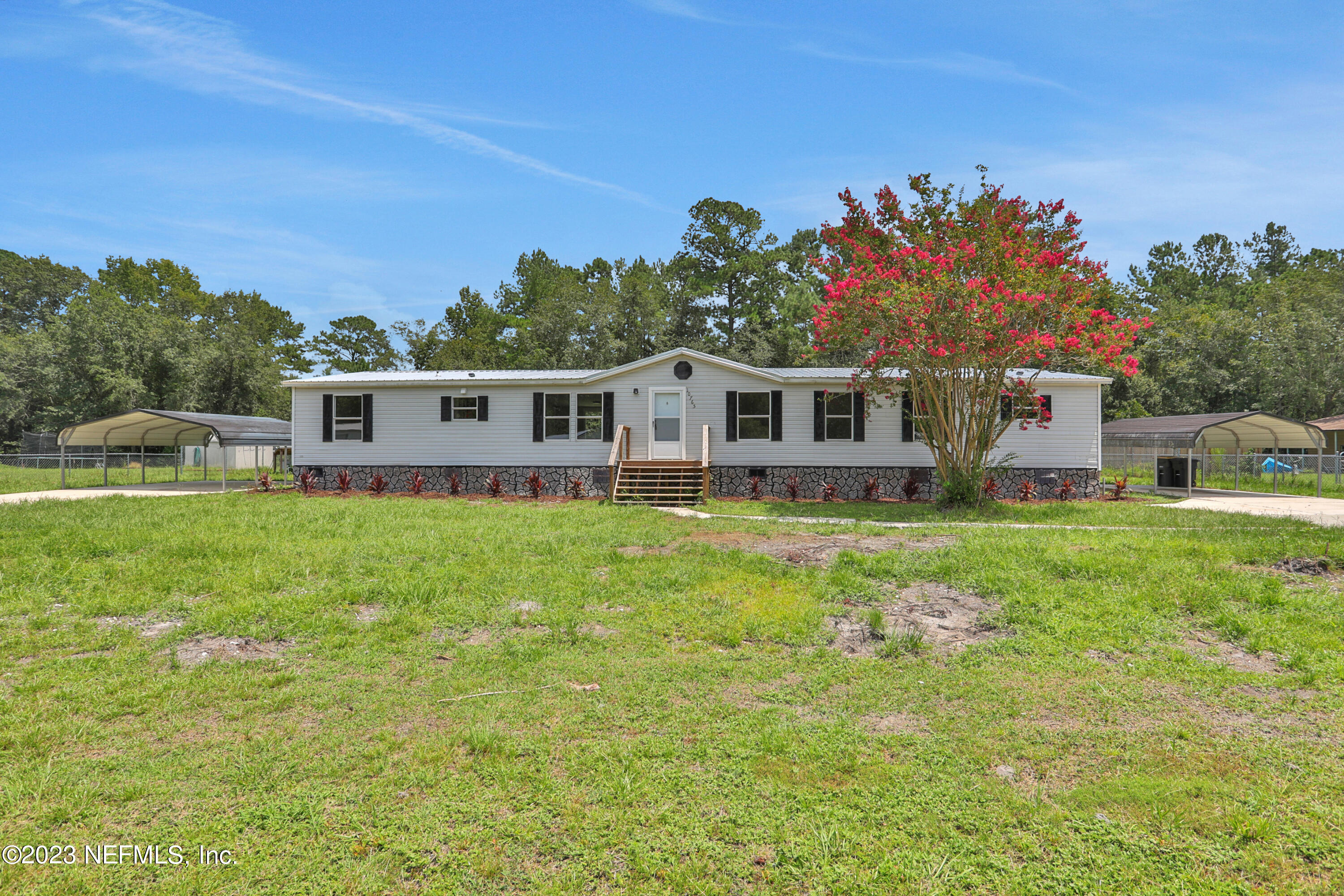 a front view of a house with a garden