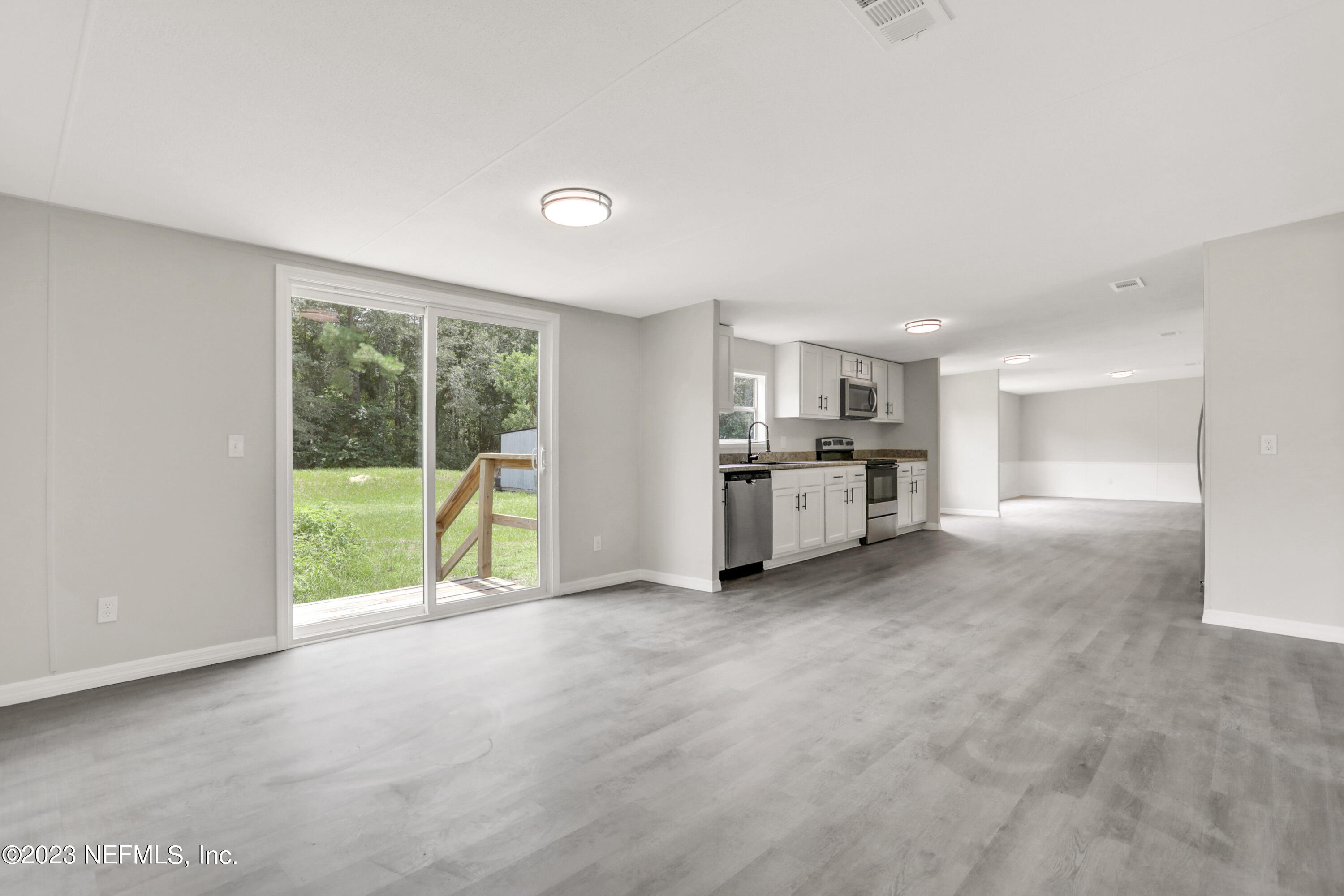 10765 Boddens Road Jacksonville, FL 32219 - Photo 12 of 39 a view of a kitchen with furniture and an empty room
