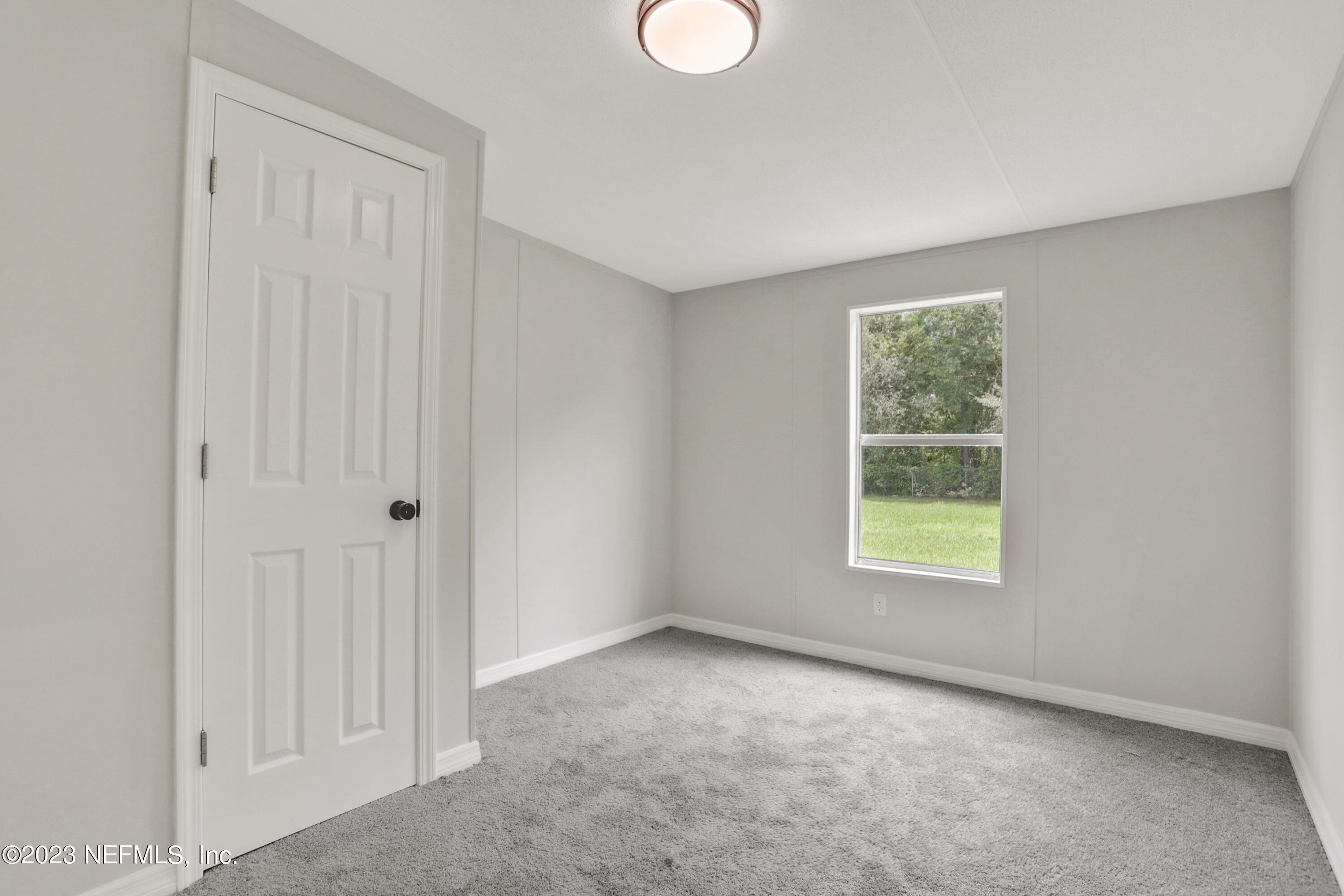 10765 Boddens Road Jacksonville, FL 32219 - Photo 16 of 39 an empty room with windows and closet