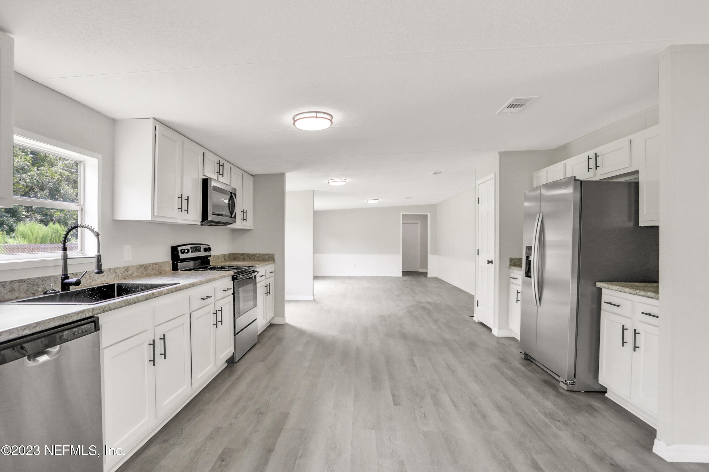 10765 Boddens Road Jacksonville, FL 32219 - Photo 19 of 39 a large kitchen with a lot of counter space and stainless steel appliances