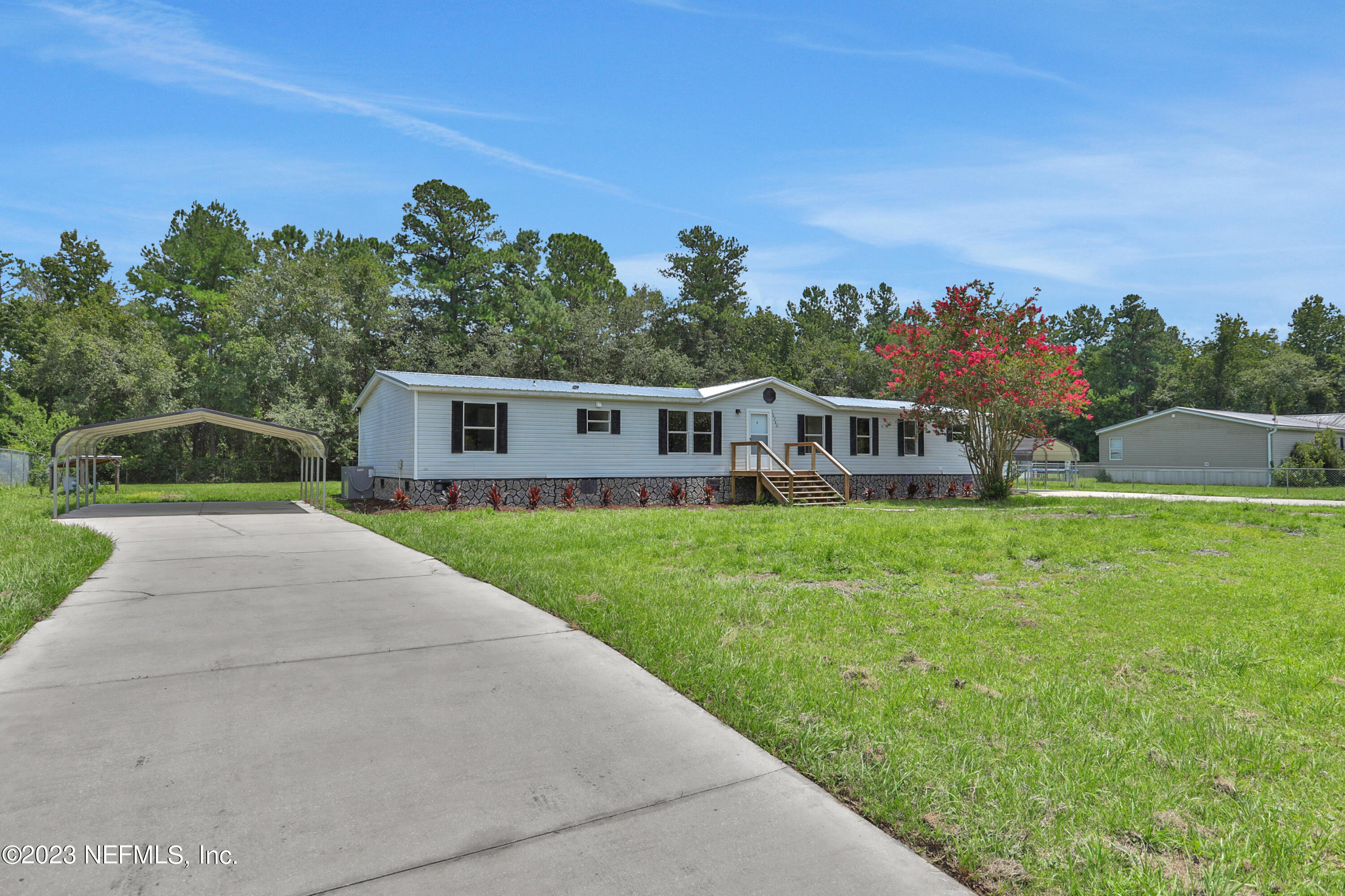 10765 Boddens Road Jacksonville, FL 32219 - Photo 2 of 39 a front view of a house with garden