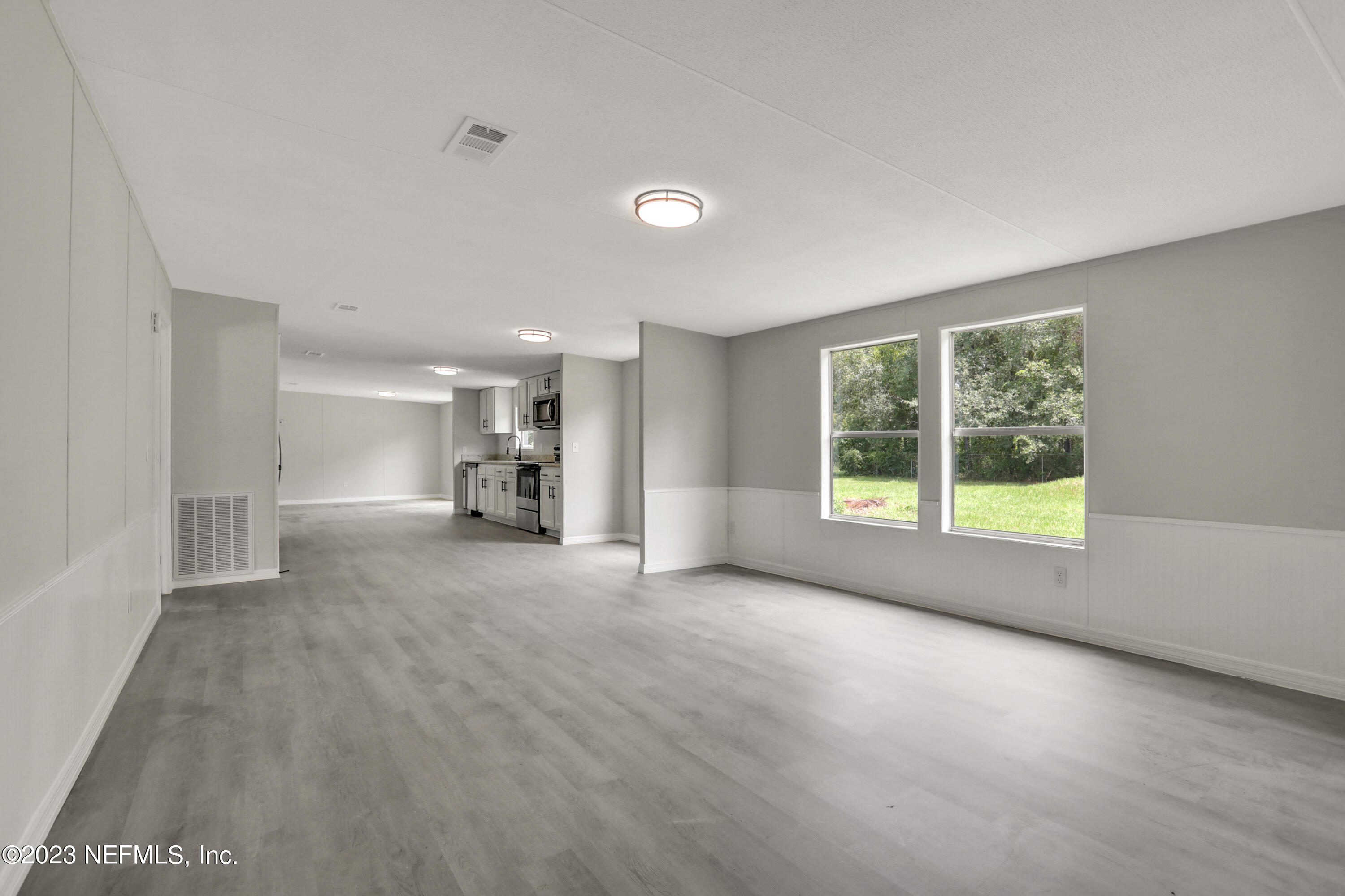 10765 Boddens Road Jacksonville, FL 32219 - Photo 23 of 39 a view of empty room with a window and kitchen view