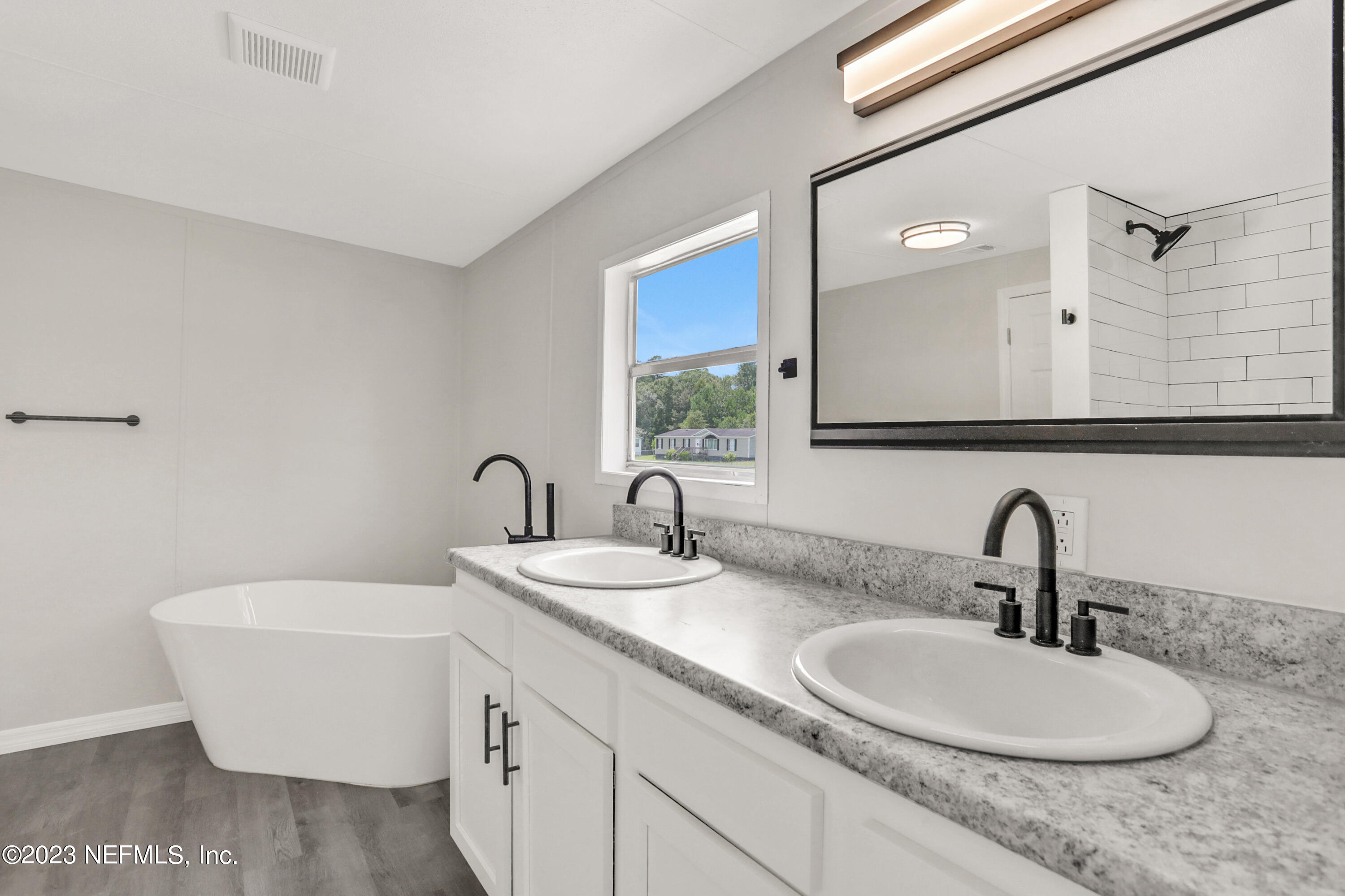 10765 Boddens Road Jacksonville, FL 32219 - Photo 30 of 39 a bathroom with a sink and a mirror