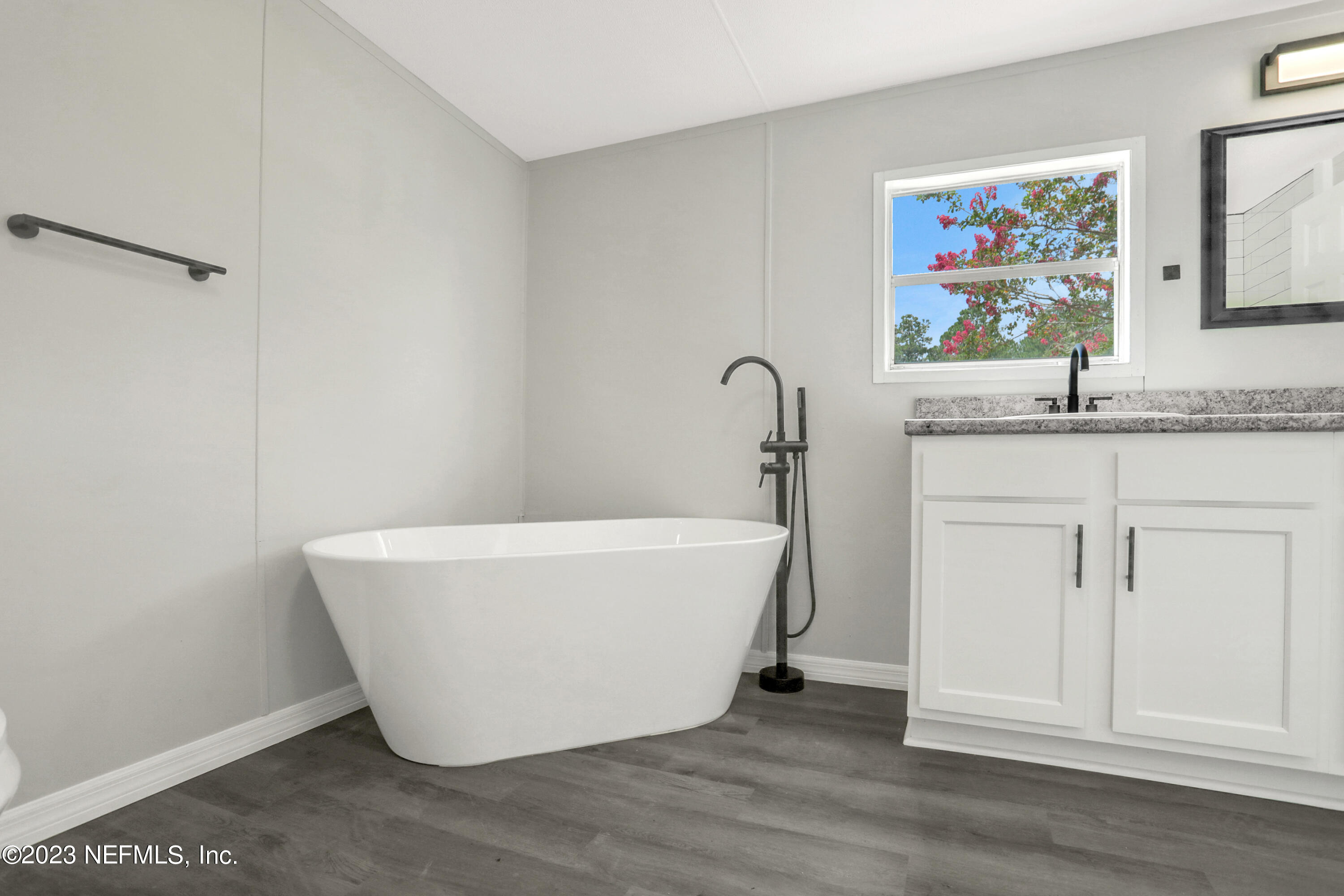 10765 Boddens Road Jacksonville, FL 32219 - Photo 31 of 39 a white bath tub sitting next to a window