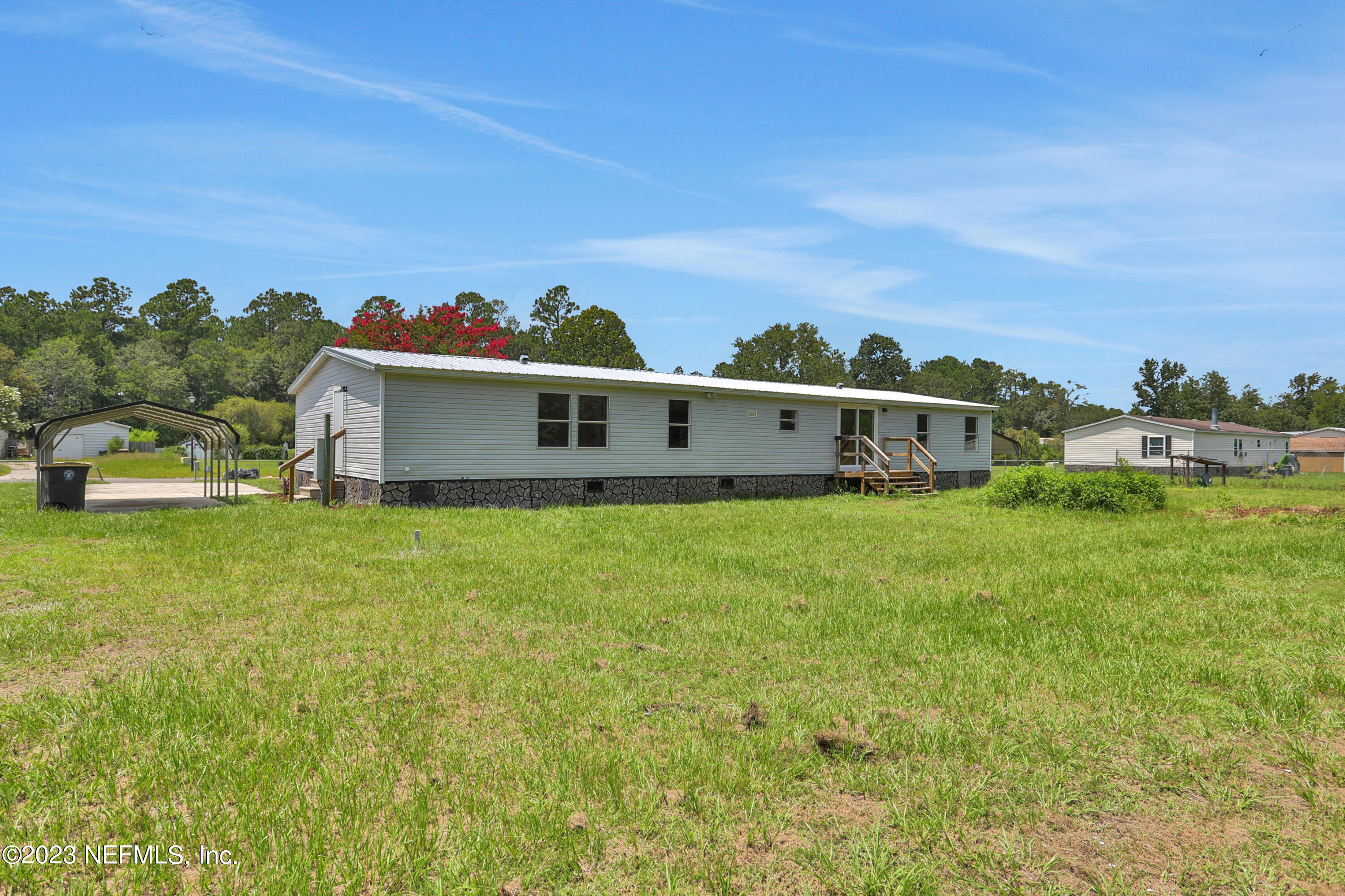 10765 Boddens Road Jacksonville, FL 32219 - Photo 37 of 39 a view of a house with a big yard and a large tree