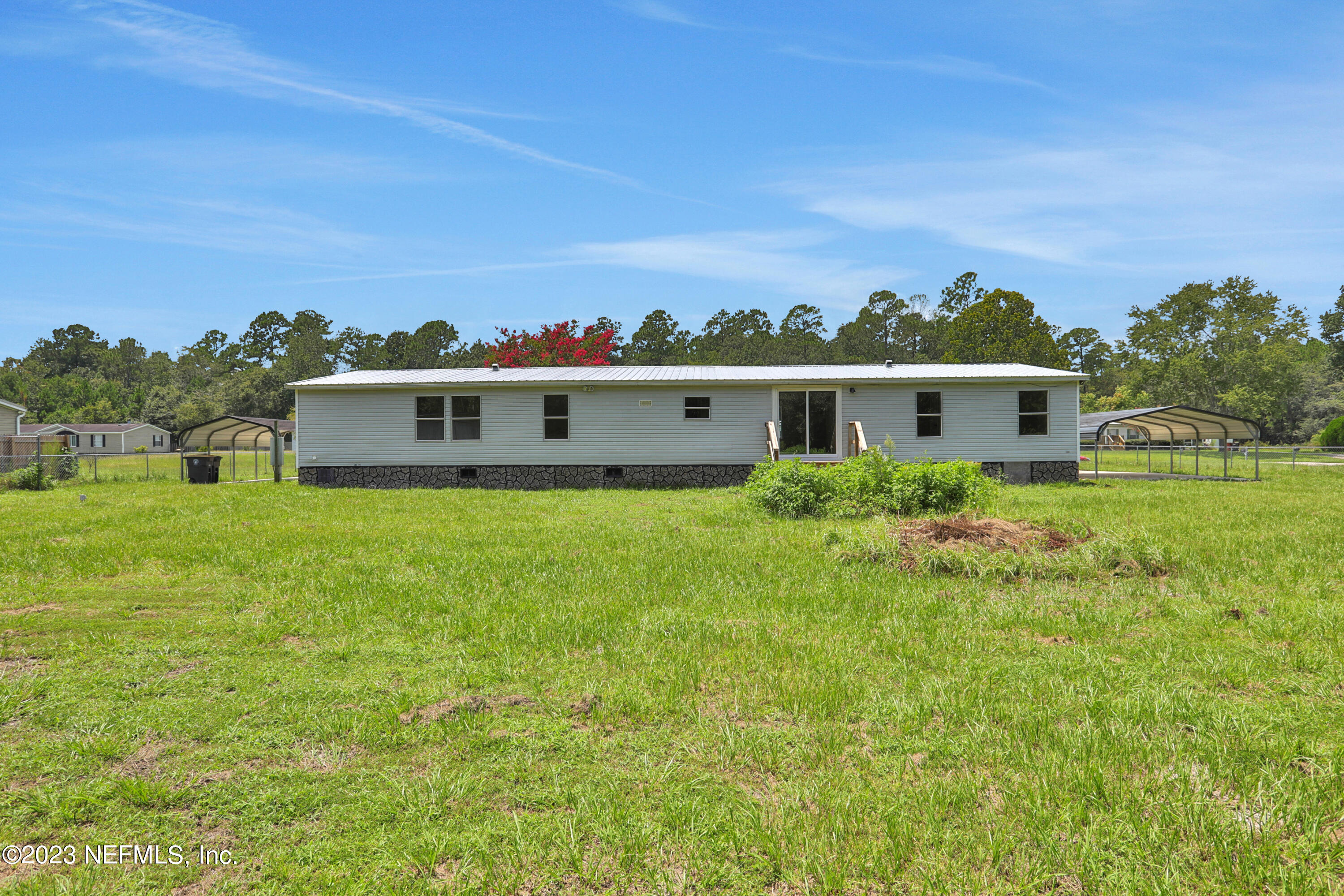 10765 Boddens Road Jacksonville, FL 32219 - Photo 38 of 39 a view of a big house with a big yard