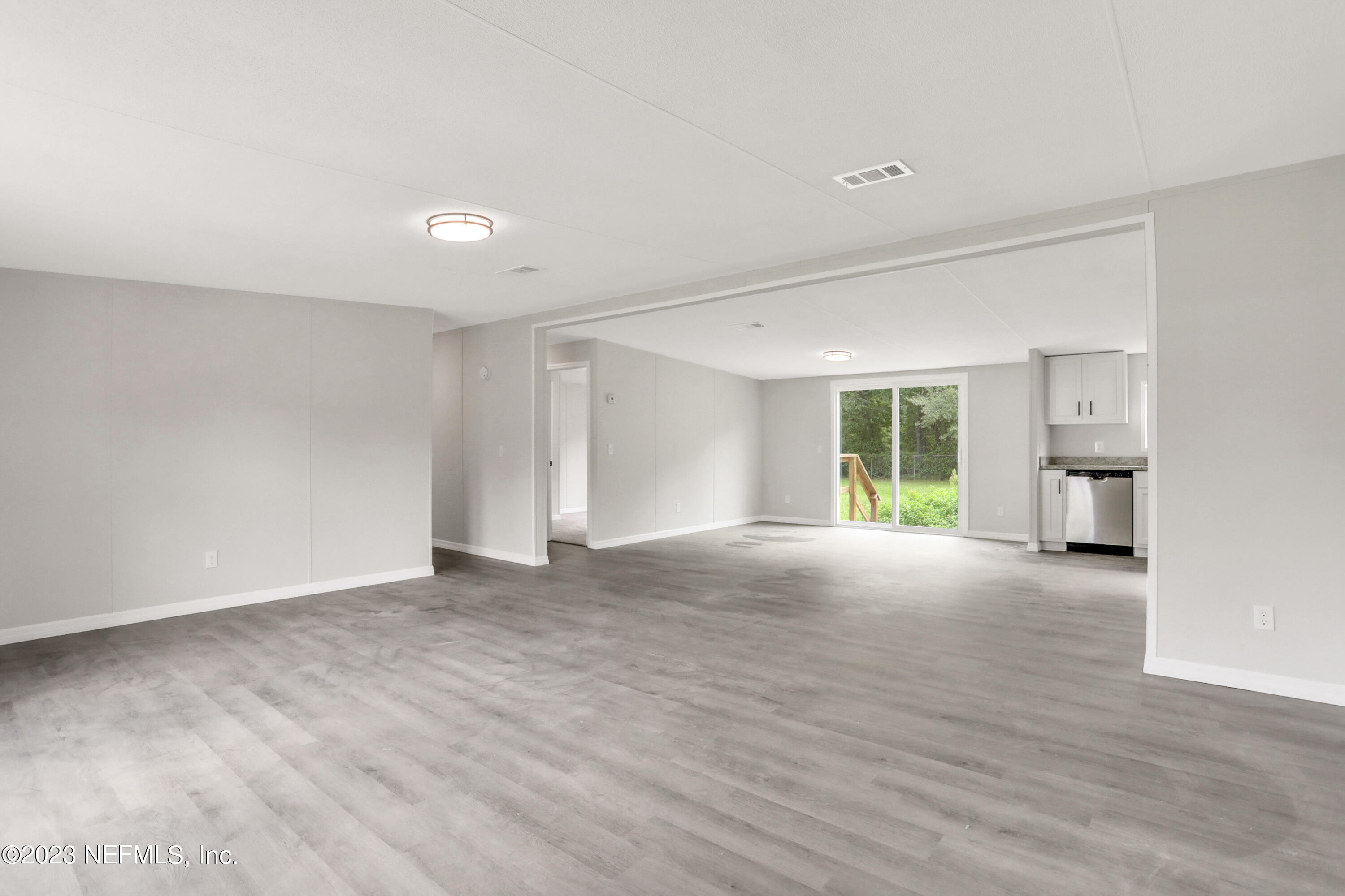 10765 Boddens Road Jacksonville, FL 32219 - Photo 5 of 39 a view of empty room with a kitchen and fireplace