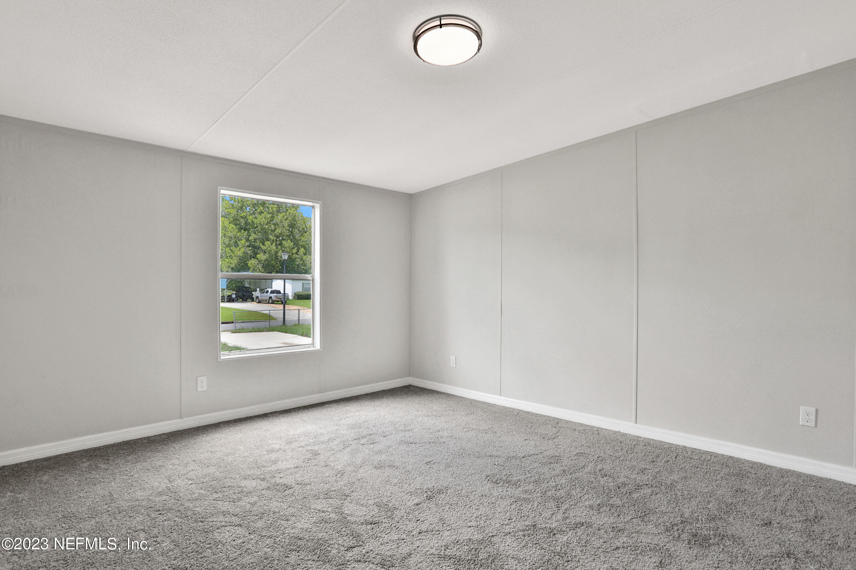 10765 Boddens Road Jacksonville, FL 32219 - Photo 8 of 39 an empty room with windows