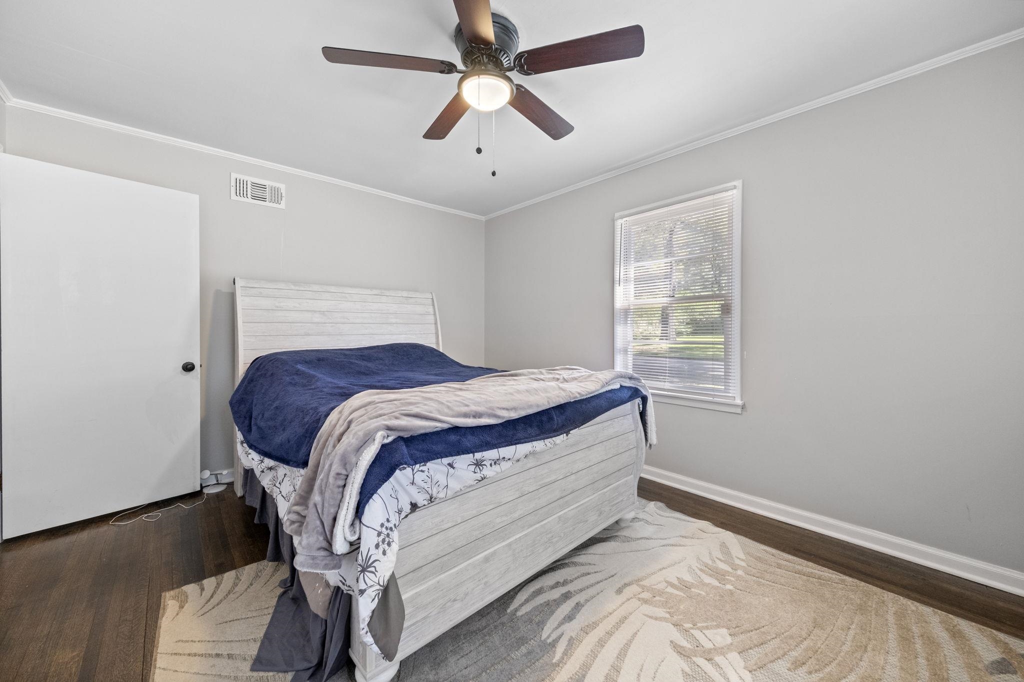 1435 Flamingo Road Memphis, TN 38117 - Photo 13 of 29 a bed sitting in a bedroom next to a window