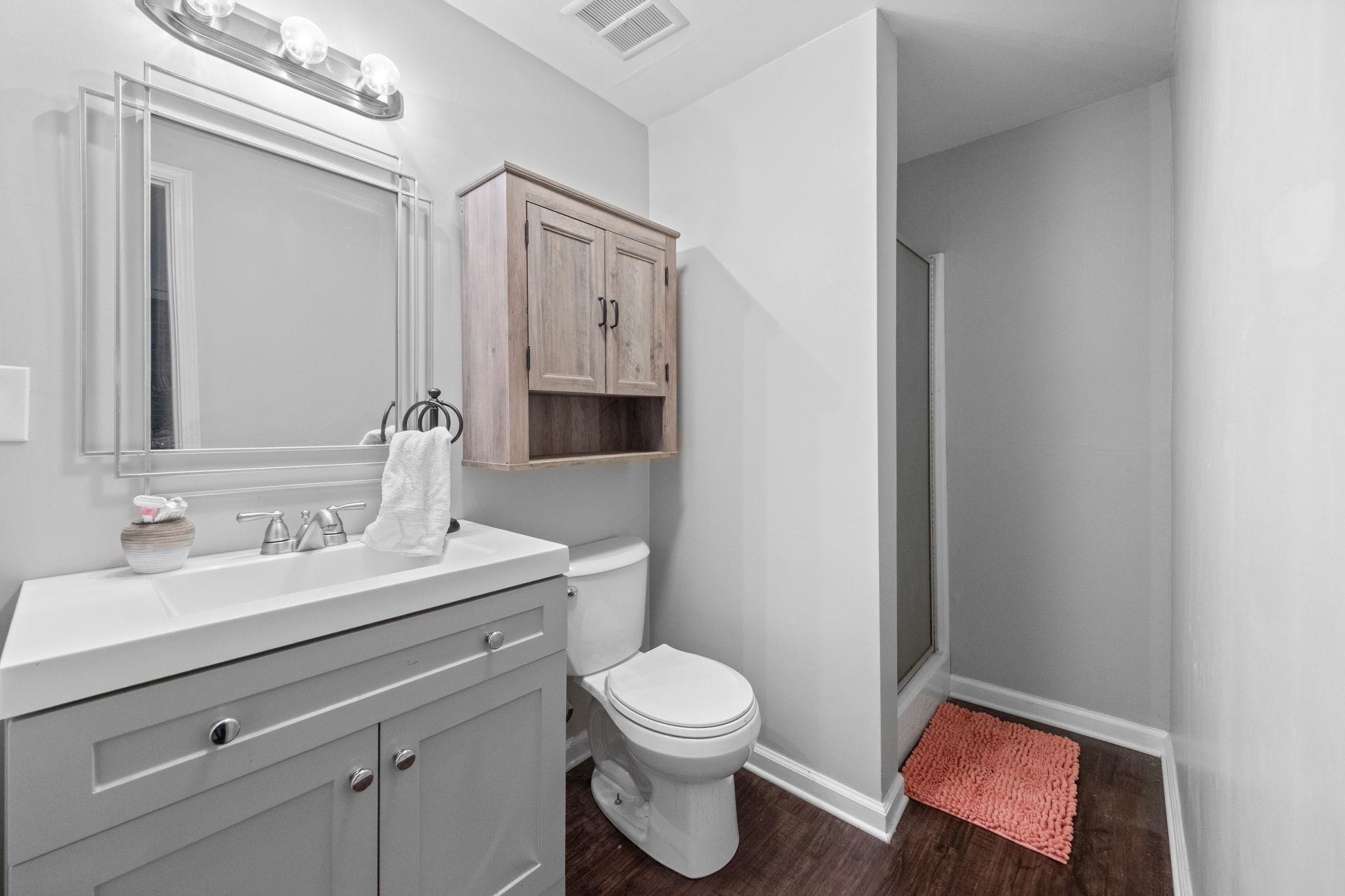 1435 Flamingo Road Memphis, TN 38117 - Photo 15 of 29 a bathroom with a toilet a sink a mirror and vanity