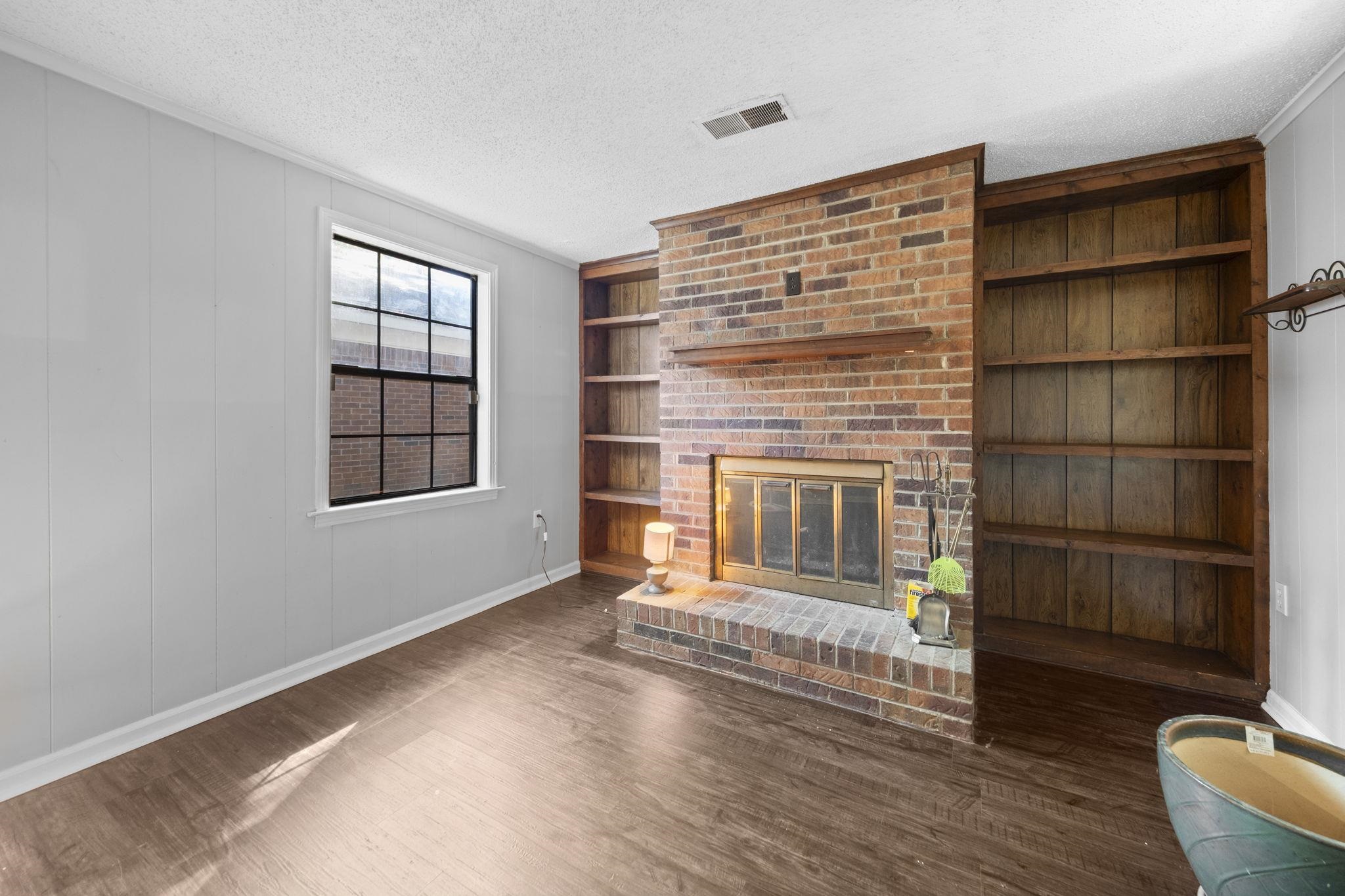 1435 Flamingo Road Memphis, TN 38117 - Photo 5 of 29 a view of an empty room with a window and wooden floor