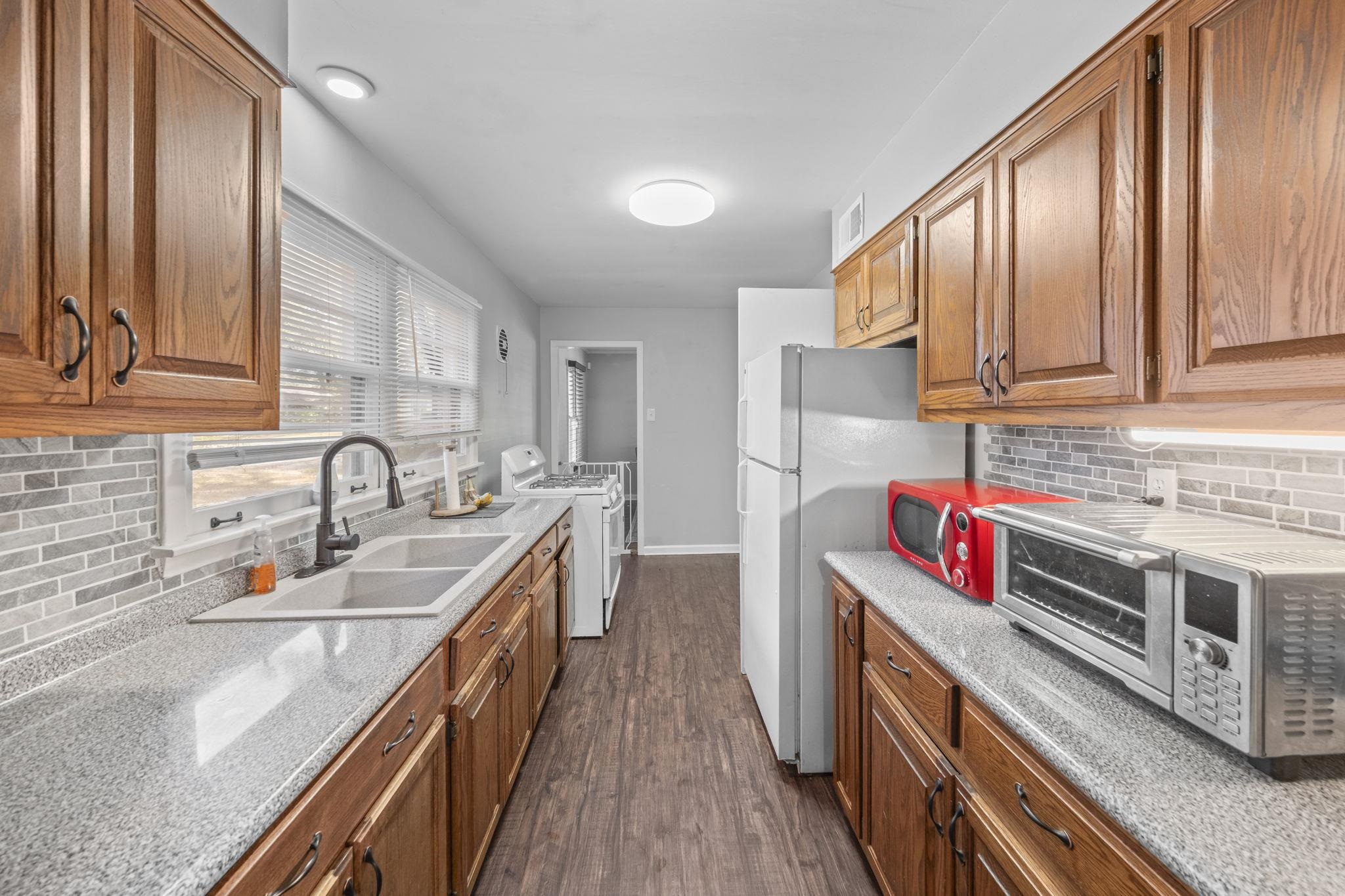 1435 Flamingo Road Memphis, TN 38117 - Photo 6 of 29 a kitchen with stainless steel appliances granite countertop a stove and a sink