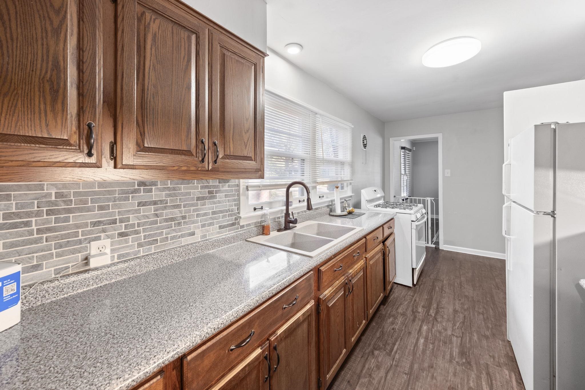 1435 Flamingo Road Memphis, TN 38117 - Photo 7 of 29 a kitchen with stainless steel appliances granite countertop a sink stove and refrigerator