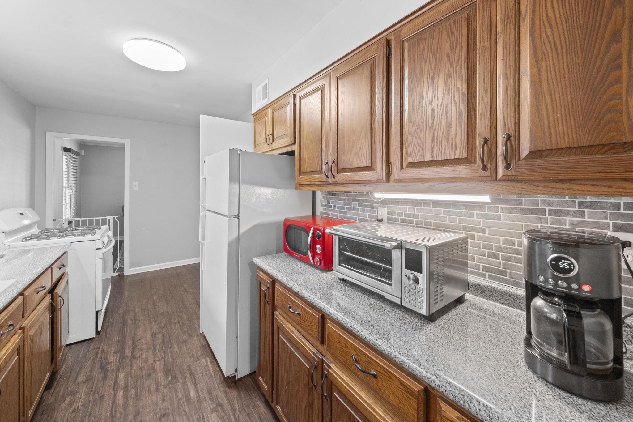 1435 Flamingo Road Memphis, TN 38117 - Photo 8 of 29 a kitchen with stainless steel appliances granite countertop a stove and a sink