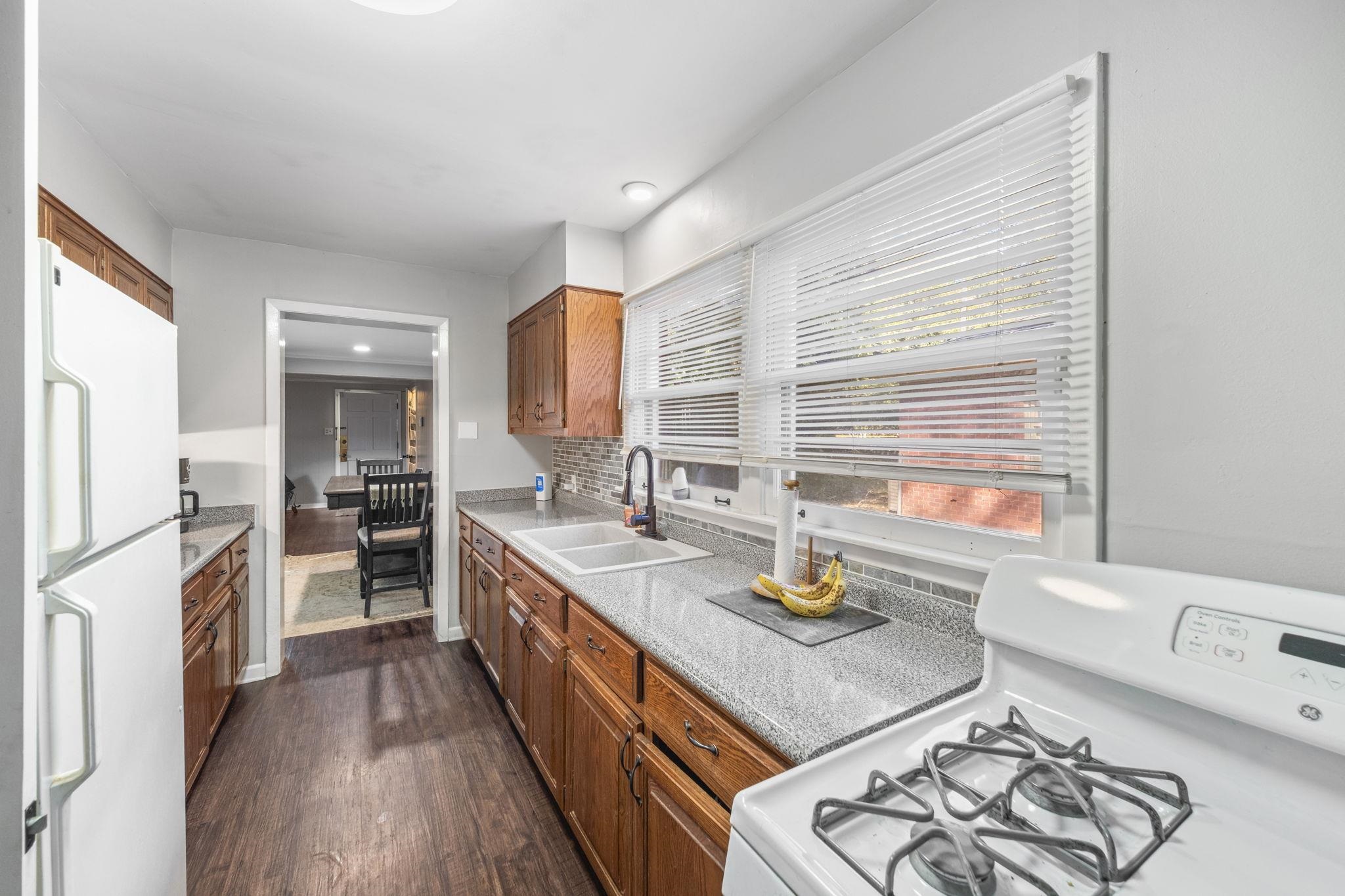 1435 Flamingo Road Memphis, TN 38117 - Photo 10 of 29 a kitchen with stainless steel appliances granite countertop a sink stove and refrigerator