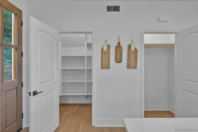 a dining room with furniture a potted plant and a painting