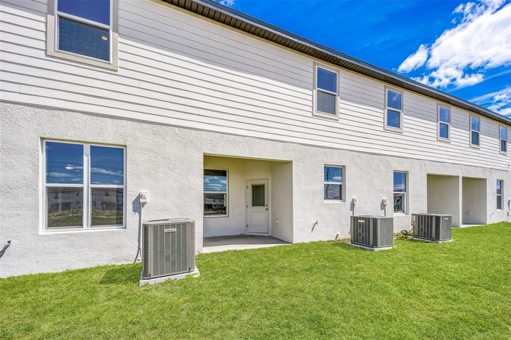 793 Poppy Lane Dundee, FL 33838 - Photo 2 of 16 a front view of a house with a yard