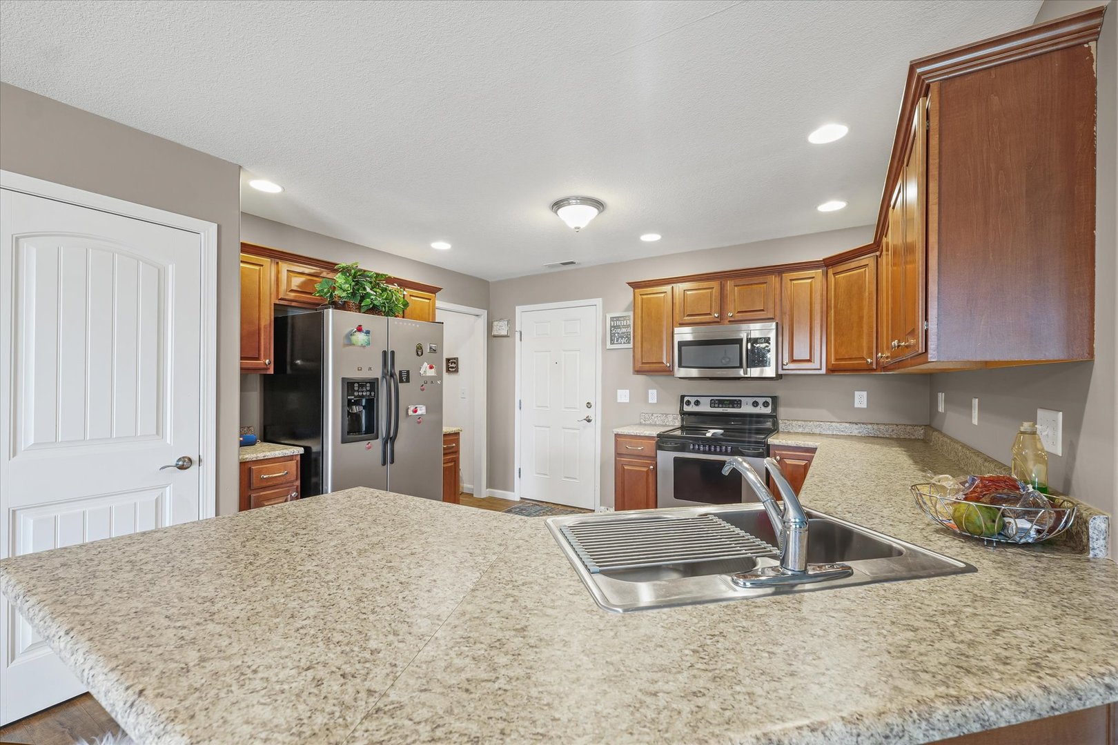 634 Sedgegrass Drive Champaign, IL 61822 - Photo 14 of 35 a kitchen with stainless steel appliances granite countertop a sink refrigerator and cabinets