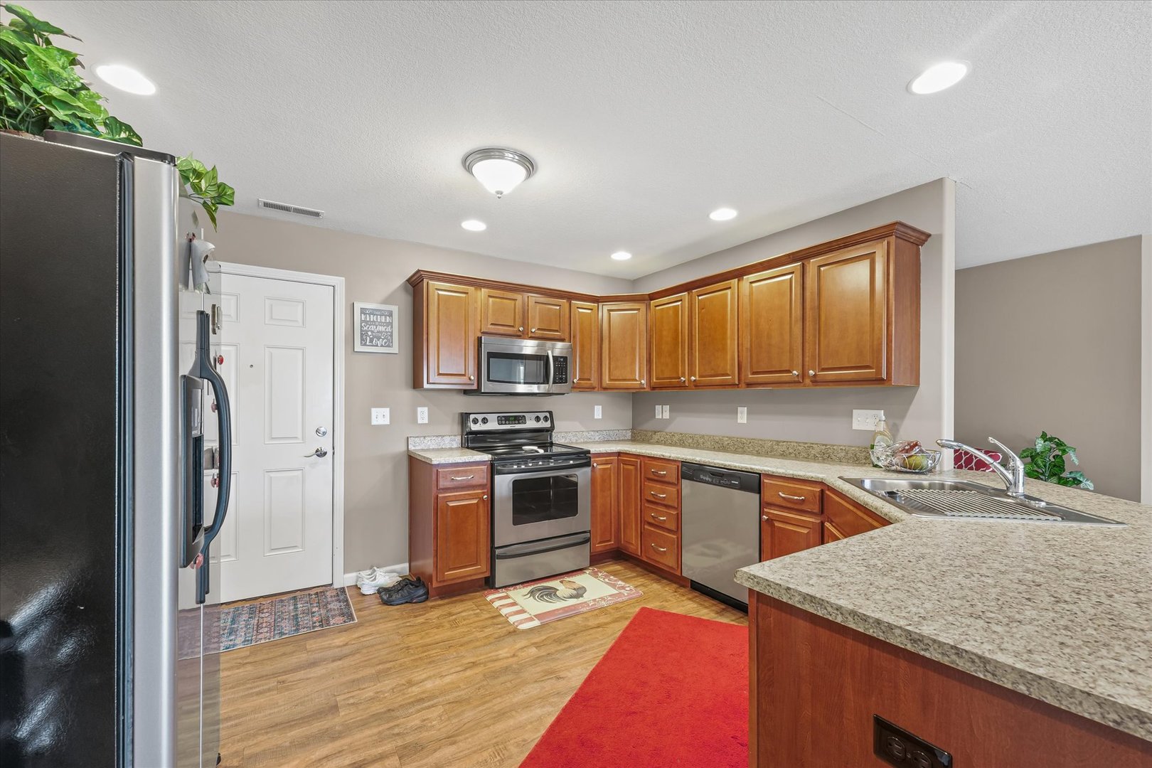 634 Sedgegrass Drive Champaign, IL 61822 - Photo 15 of 35 a kitchen with stainless steel appliances granite countertop refrigerator sink and stove