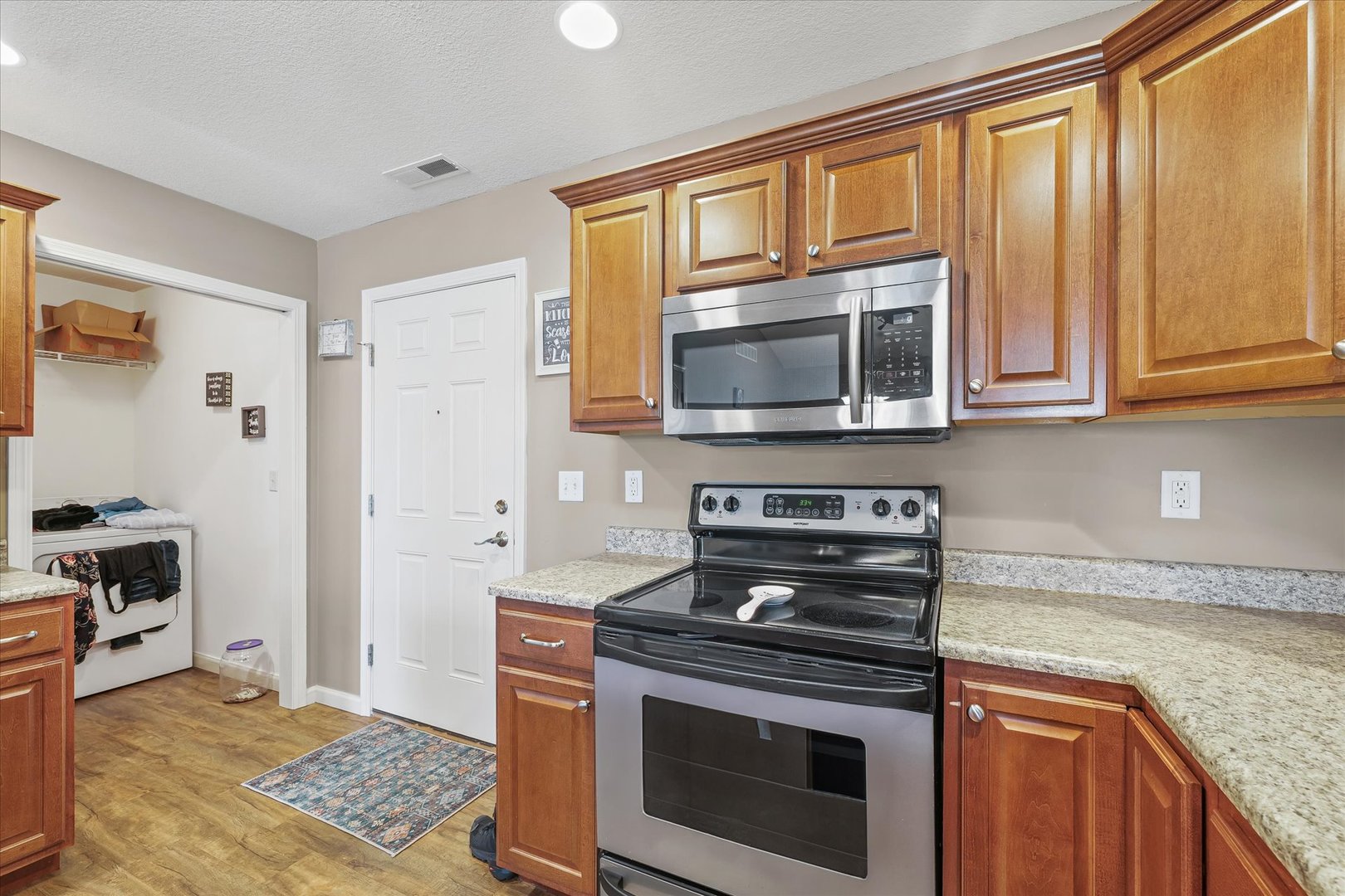 634 Sedgegrass Drive Champaign, IL 61822 - Photo 16 of 35 a kitchen with granite countertop a stove and a microwave