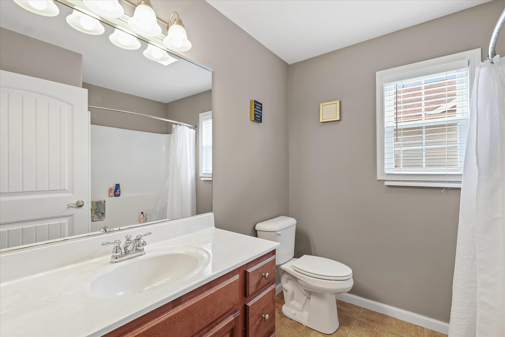 634 Sedgegrass Drive Champaign, IL 61822 - Photo 26 of 35 a bathroom with a sink a toilet and a mirror