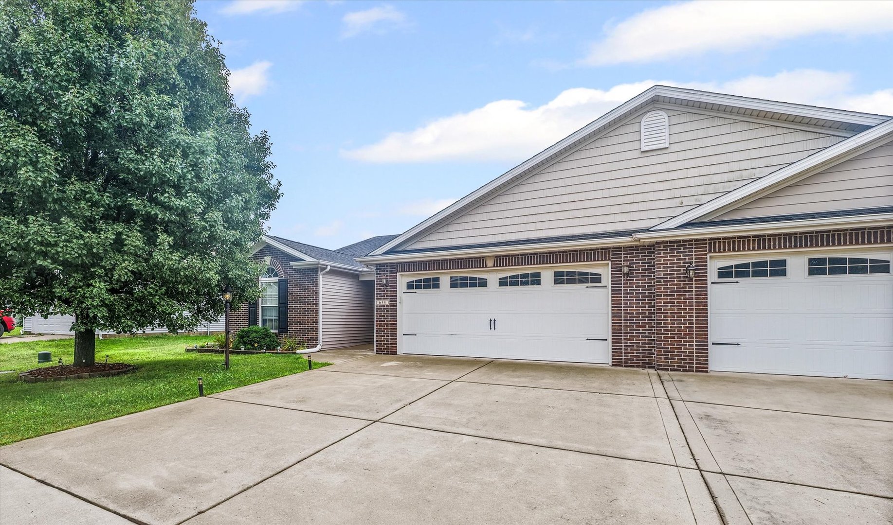 634 Sedgegrass Drive Champaign, IL 61822 - Photo 3 of 35 a view of a white house with a yard and garage