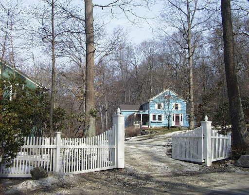 a view of a house with a wooden fence