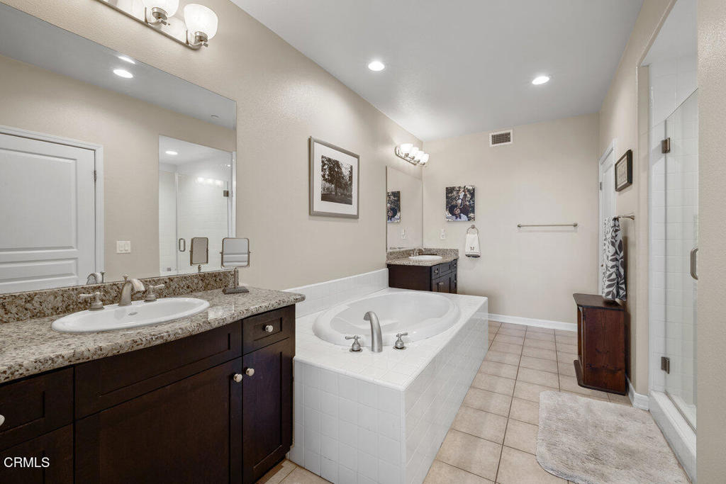1544 Seabridge Lane Oxnard, CA 93035 - Photo 22 of 30 a bathroom with a granite countertop sink and a bathtub